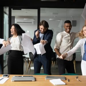 Overjoyed multiethnic colleagues have fun celebrating in office culture employees happy excited positive work environment team talent