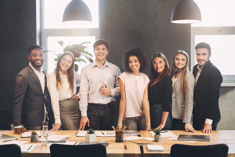 Successful managers posing and looking at camera in office