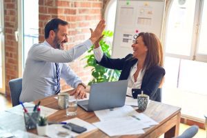 business employees working together in happy environment high five each other and excited about the success