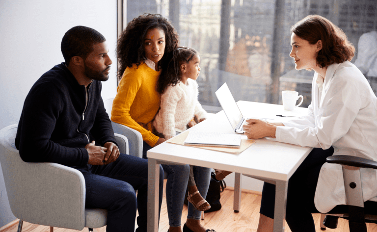 healthcare family sitting in doctors office to manage wellness and physical health