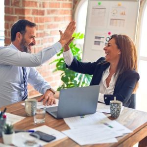 business employees working together in happy environment high five each other and excited about the success