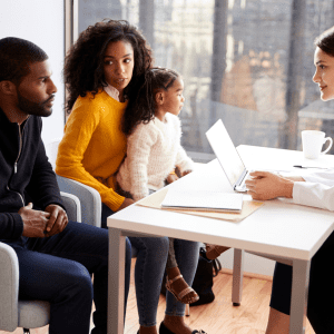 healthcare family sitting in doctors office to manage wellness and physical health