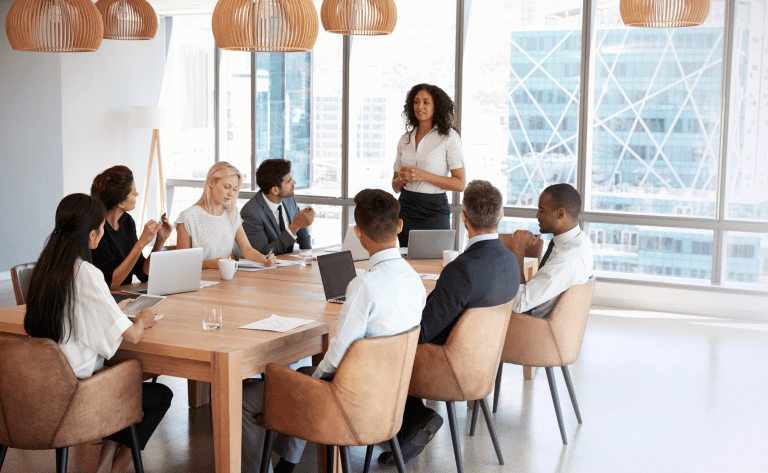 A team meeting with a diverse set of employees, attending to important issues within the business that need to be addressed on how to ensure success in their company