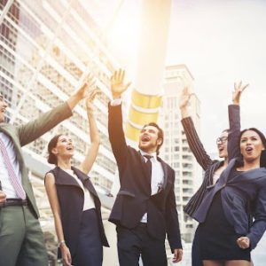 A team of happy employees celebrating a great result from working together to achieve success