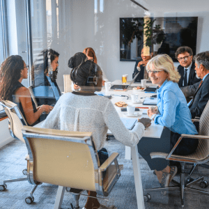 Team of board members from diverse backgrounds all working together in a happy environment to ensure the company is being productive with their employees helping achieve company objectives