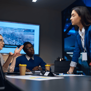 A diverse of male and female employees talking together to work out how to proceed with a complicated matter they are dealing with in the workplace.