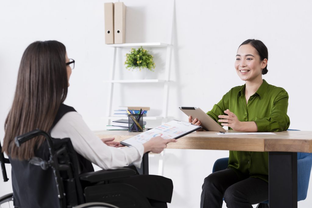 employees talking recruitment meeting disability wheelchair employees women discussing injury safety