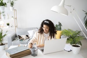 medium-shot-woman-working-desk-with-laptop-remote working working from home employees employers