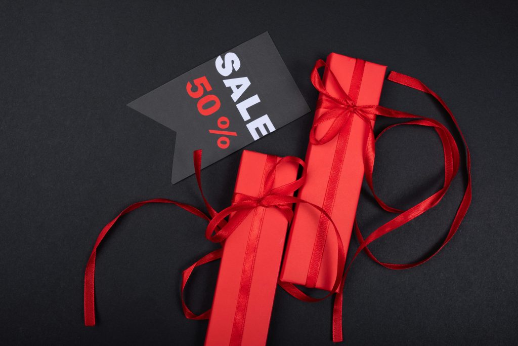 sale 50% https://www.pexels.com/photo/red-gifts-beside-a-sale-tag-7957747/