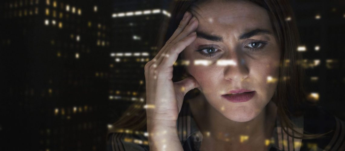 Worried Caucasian businesswoman with hand on head