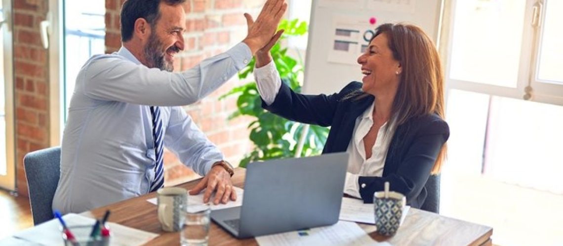 business employees working together in happy environment high five each other and excited about the success