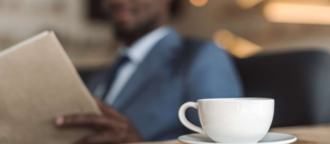 Businessman-reading-with-coffee