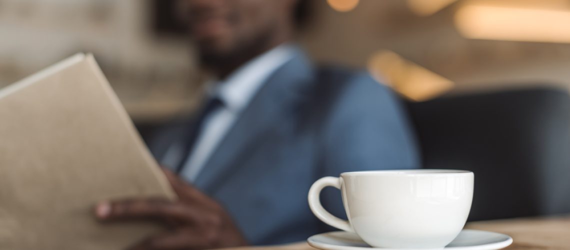 Businessman-reading-with-coffee