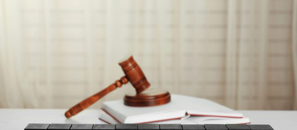 Black cubes with word IMMIGRATION and gavel on white table