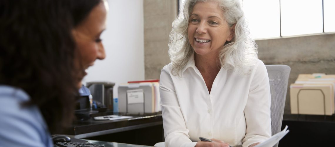 Senior professional woman meeting in office with young woman