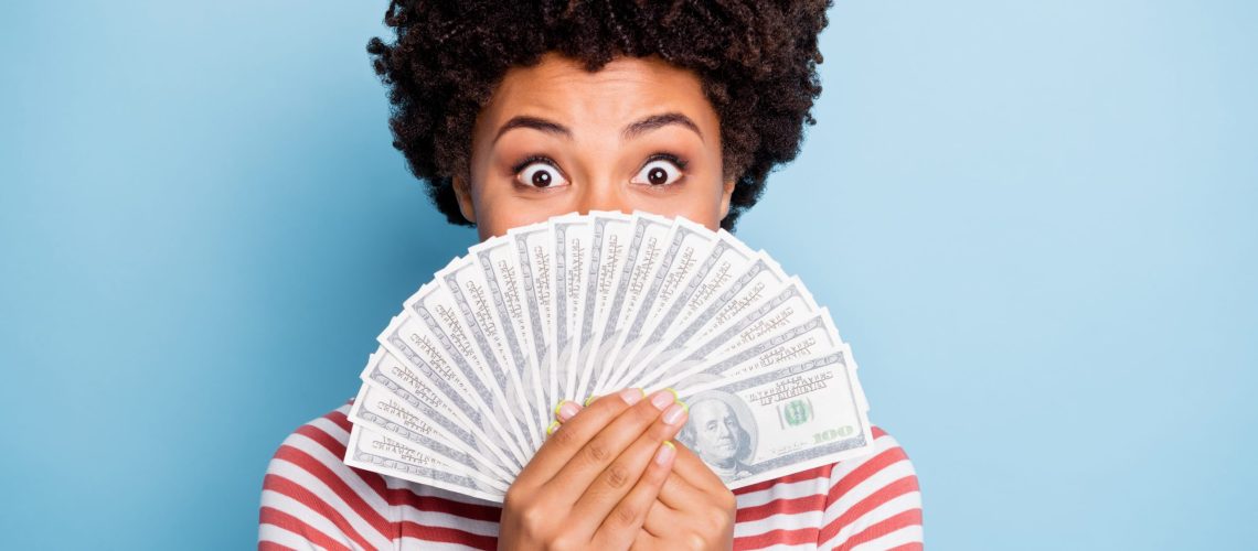 Close up portrait of cheerful positive cute curly wavy nice pretty youngster, having gained victory at lottery expressing amazement on face isolated pastel blue color background