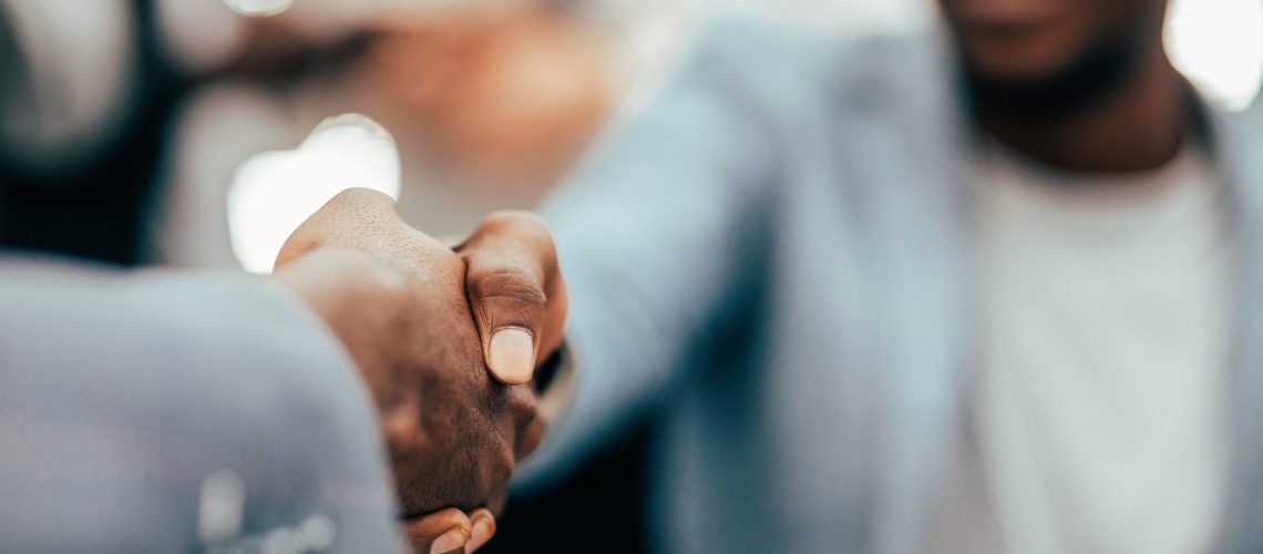 image of a handshake of business executives leadership team meeting