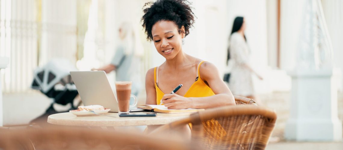 Prints a message to the mail on the laptop during the lunch break. Young woman Brazilian appearance online training in a summer cafe.