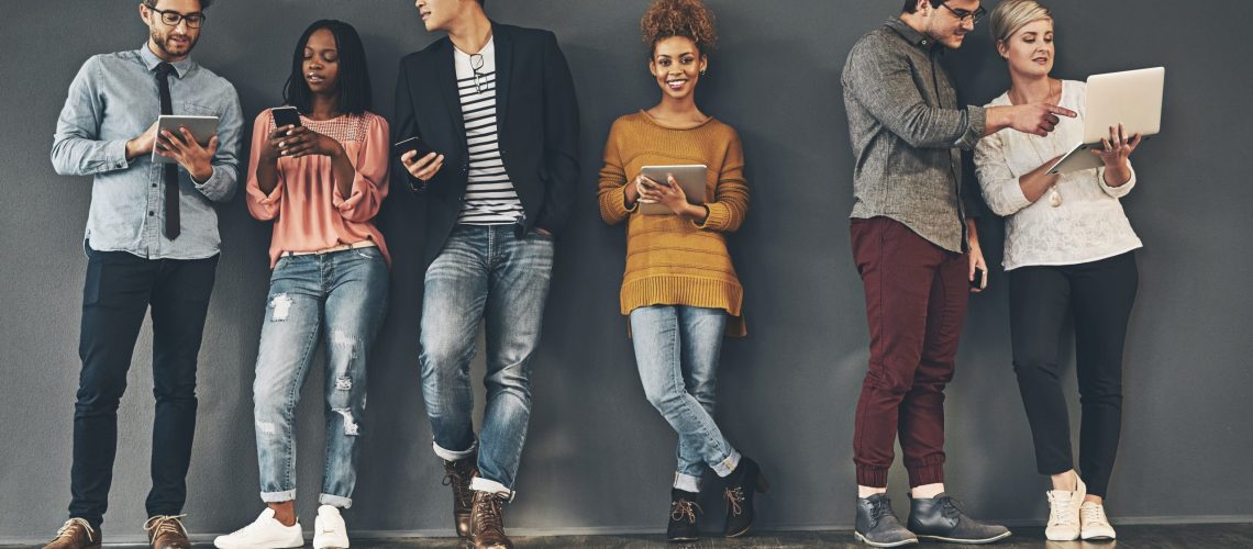 Studio shot of a diverse group of creative employees social networking inside