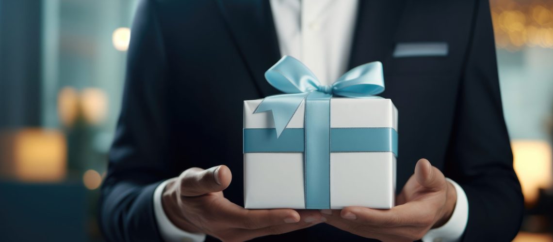 Hands of businessman in blue shirt holding gift box Business concept employee benefits