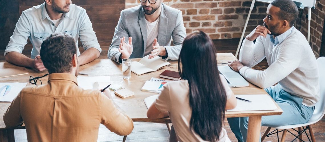 Team_meeting_talking_around_a_table