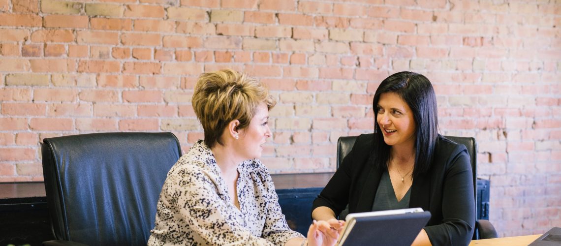 Women talking in office boardroom employees