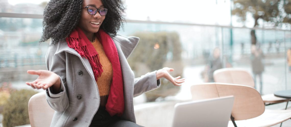 cheerful-surprised-woman-sitting-with-laptop-3762940