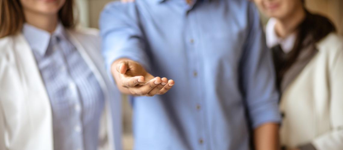 volunteer Generous leadership - 'giving' leaders or 'receiving' leaders and what they want or give to their employees. Three employees standing together with one employee or employer offering their help.