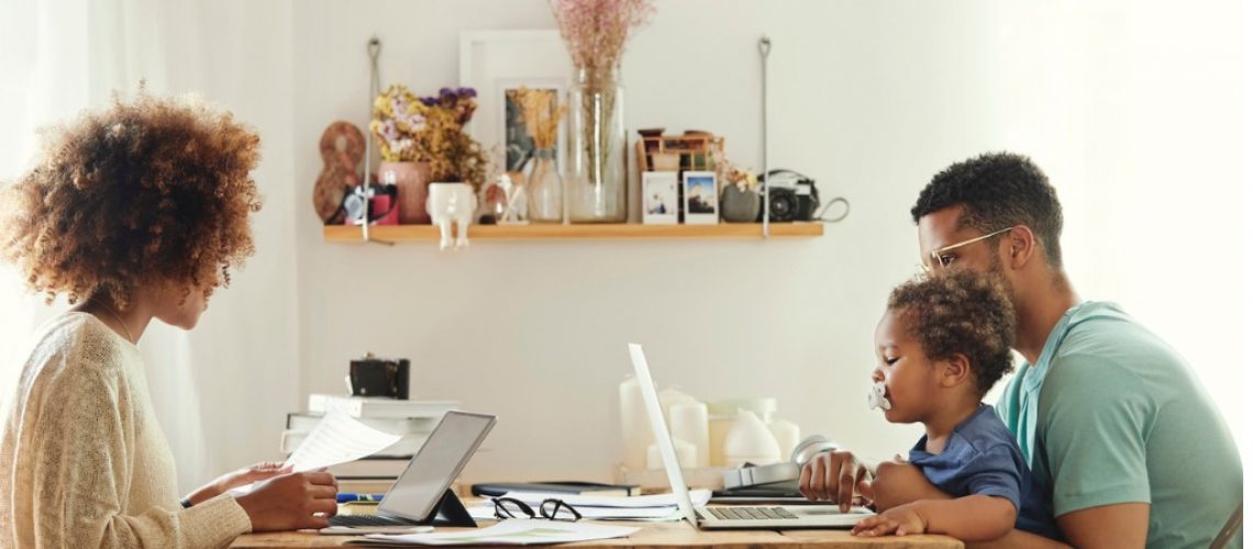 parents-using-computer-while-sitting-with-boy-picture-id1175060780-1