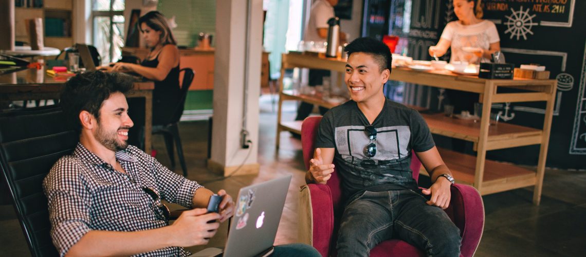 photograph-of-men-having-conversation-seating-on-chair-1015568