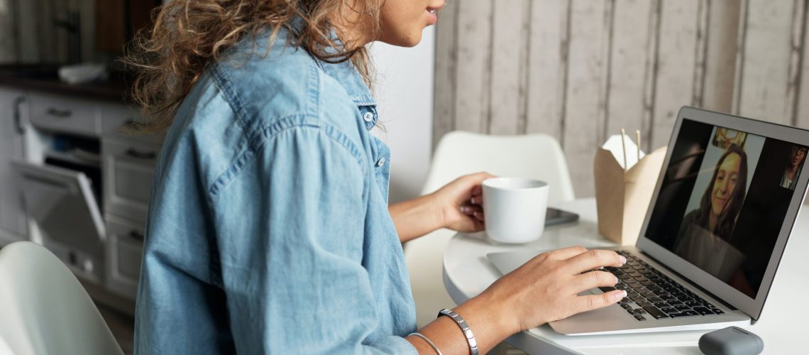 woman-in-blue-denim-jacket-using-macbook-pro-4099099