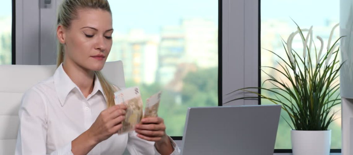 woman_counting_money_at_desk